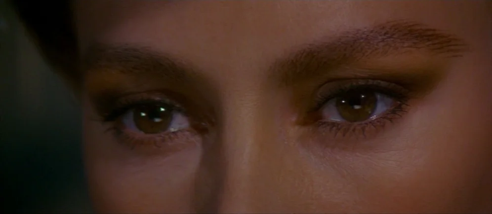 Dune (1984) movie still: closeup — A close-up view of a woman's face, focusing specifically on her brown eyes. She stares directly into the camera…
