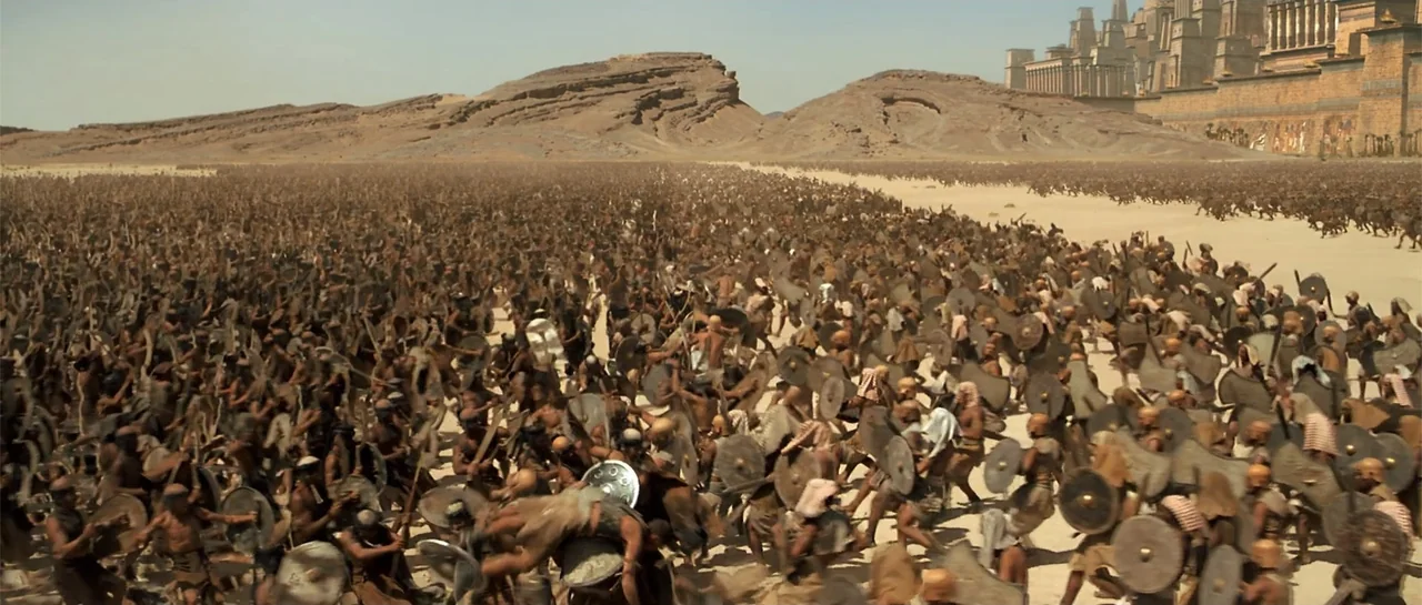 The Mummy Returns (2001) movie still: wide — A vast desert plain contains an army of thousands of armored soldiers in motion. Ancient stone city…