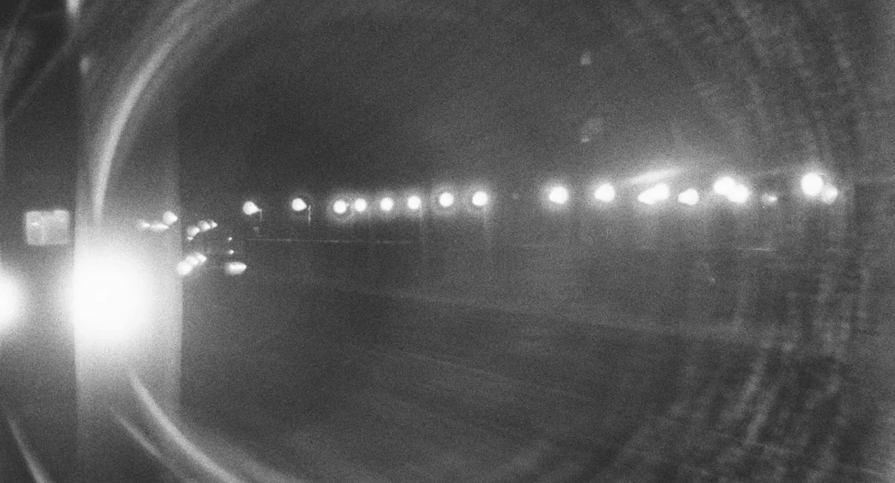 The Incident (1967) movie still: establishing — A dark subterranean train tunnel stretches out into the distance. A long row of circular lights…