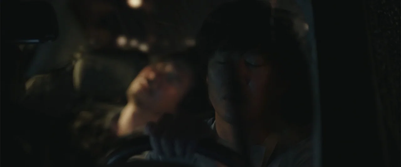 Along with the Gods: The Two Worlds (2017) movie still: medium — A dark car interior at night with limited ambient light entering from the window.…