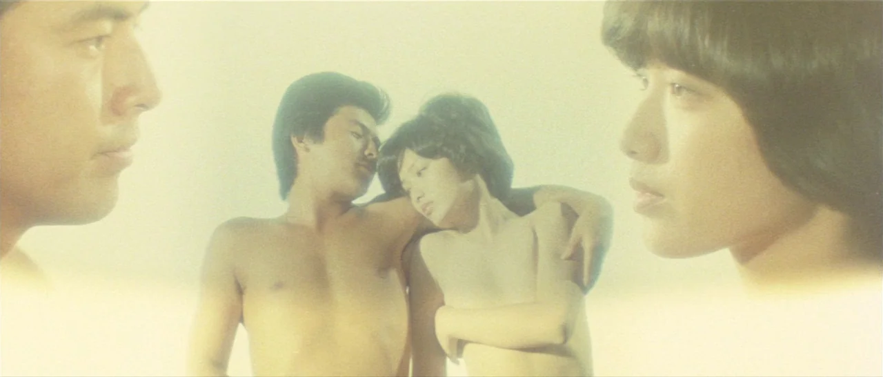 Take Me Away! (1978) movie still: medium — A high-key studio setting features two faces flanking a central couple embracing closely. The subjects…