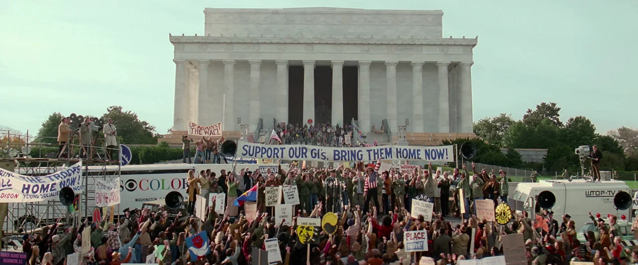 Forrest Gump (1994) movie still: wide — A large crowd of demonstrators gathers in front of the Lincoln Memorial in Washington. People hold protest…