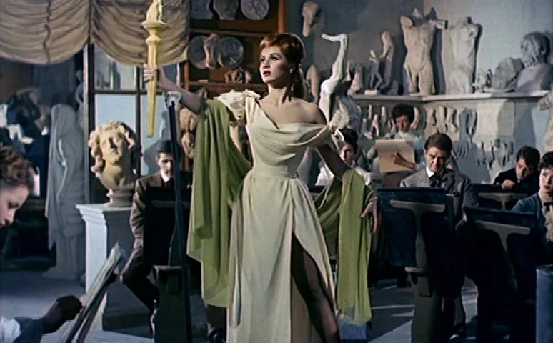 Mill of the Stone Women (1960) movie still: fullbody — An art studio is filled with plaster sculptures and several students drawing on easels. A…