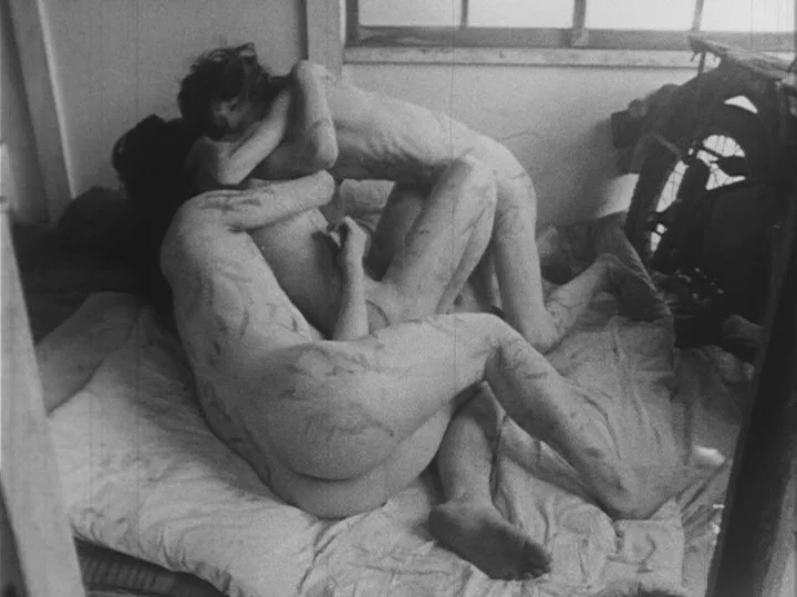 Emperor Tomato Ketchup movie still: medium — A sparse room features a mattress on the floor near a large window frame. Two slender figures are…