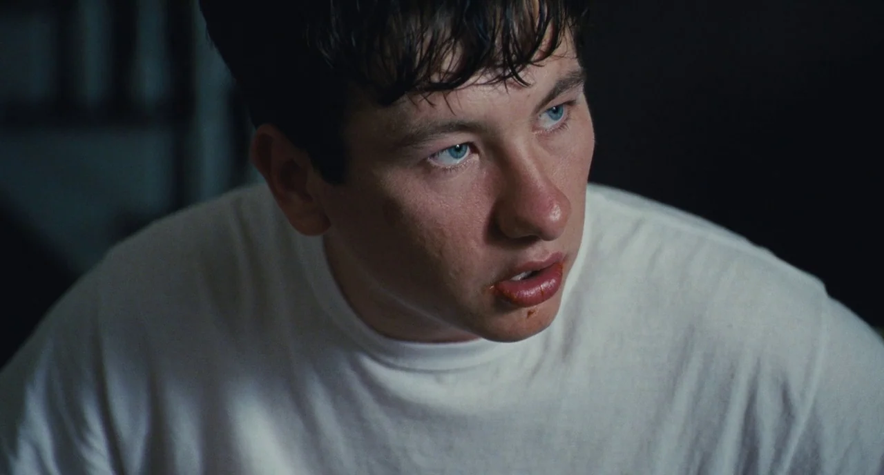 The Killing of a Sacred Deer (2017) movie still: closeup — The frame shows a dark interior space with a person as the primary focus. A man with…