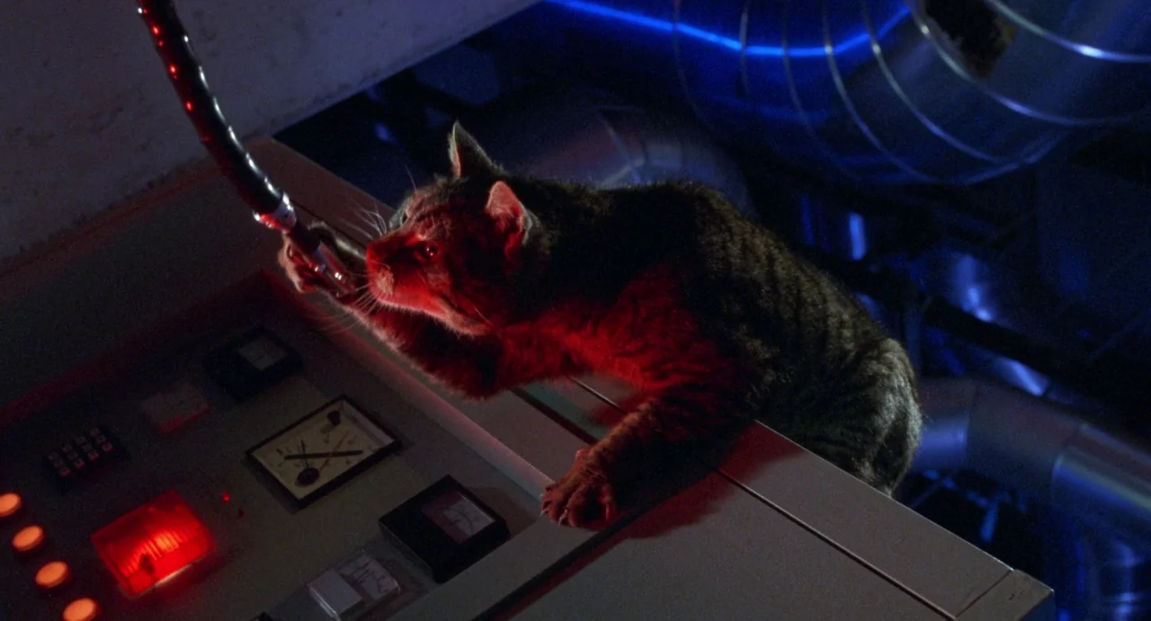 Femme Fatale (2002) movie still: medium — A dark, industrial control console features various analog meters, toggle switches, and glowing…