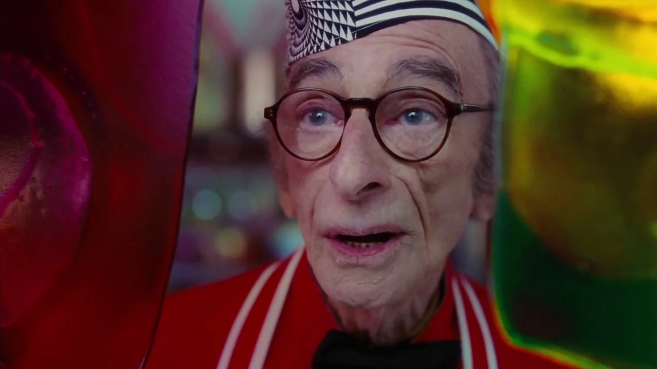 Charlie and The Chocolate Factory (2005) movie still: closeup — An ice cream parlor features bright, saturated decor with prominent foreground glass…