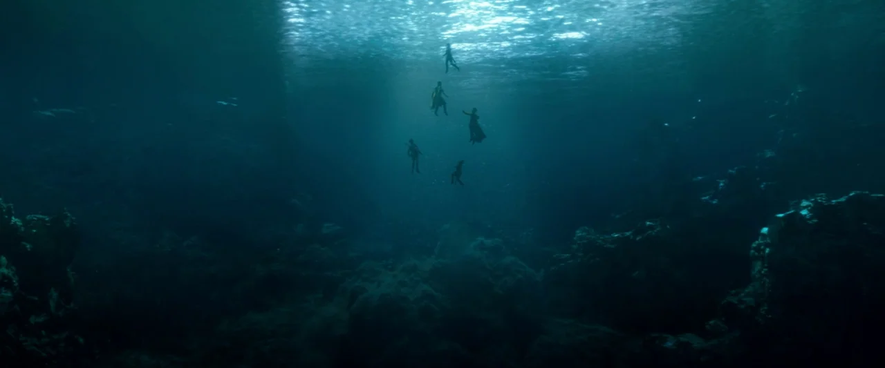 Dungeons & Dragons: Honor Among Thieves (2023) movie still: wide — A deep underwater scene features a group of swimmers descending from the bright…