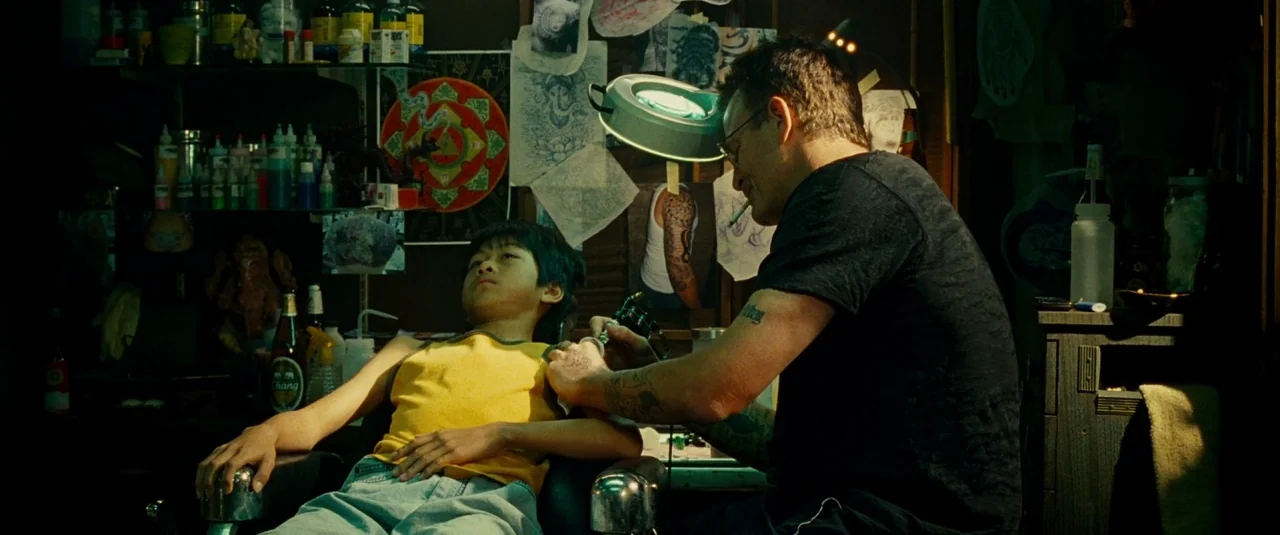 The Hangover Part II (2011) movie still: medium — A cluttered work space contains shelves of ink bottles and wall-mounted reference sketches. An…