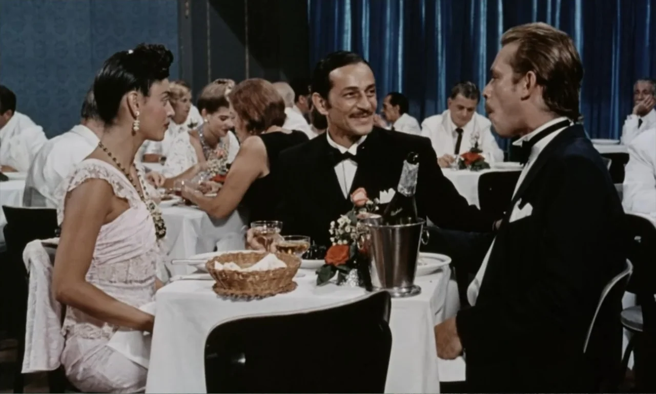 Dona Flor and Her Two Husbands (1976) movie still: medium — A formal restaurant features white-clothed tables and blue velvet curtains in the…