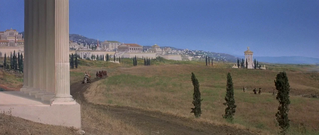 History of the World: Part 1 (1981) movie still: wide — A sprawling classical landscape features white marble structures and temples across rolling…