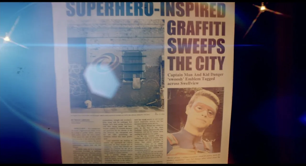 Henry Danger: The Movie (2025) movie still: closeup — A close-up view of a newspaper page featuring a headline and a portrait photo. The newspaper…