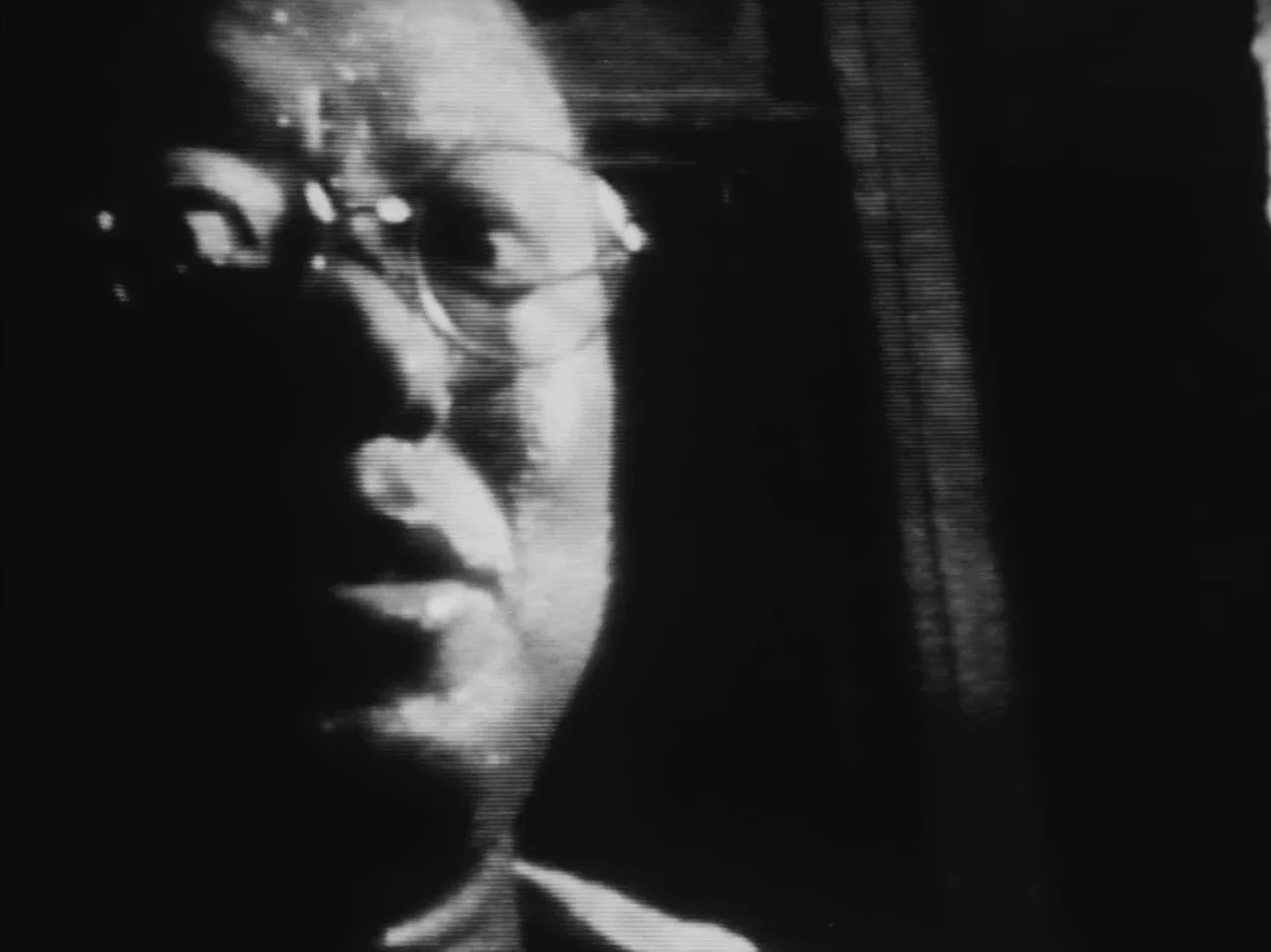 Tetsuo: The Iron Man (1989) movie still: closeup — A close-up shot captured on low-quality analog video with prominent horizontal scanning lines. A…