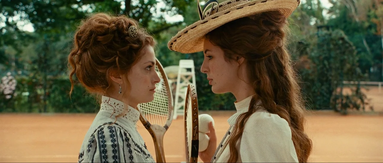 The Extraordinary Adventures of Adèle Blanc-Sec (2010) movie still: medium — Two women stand facing each other on an outdoor clay court. Both women…