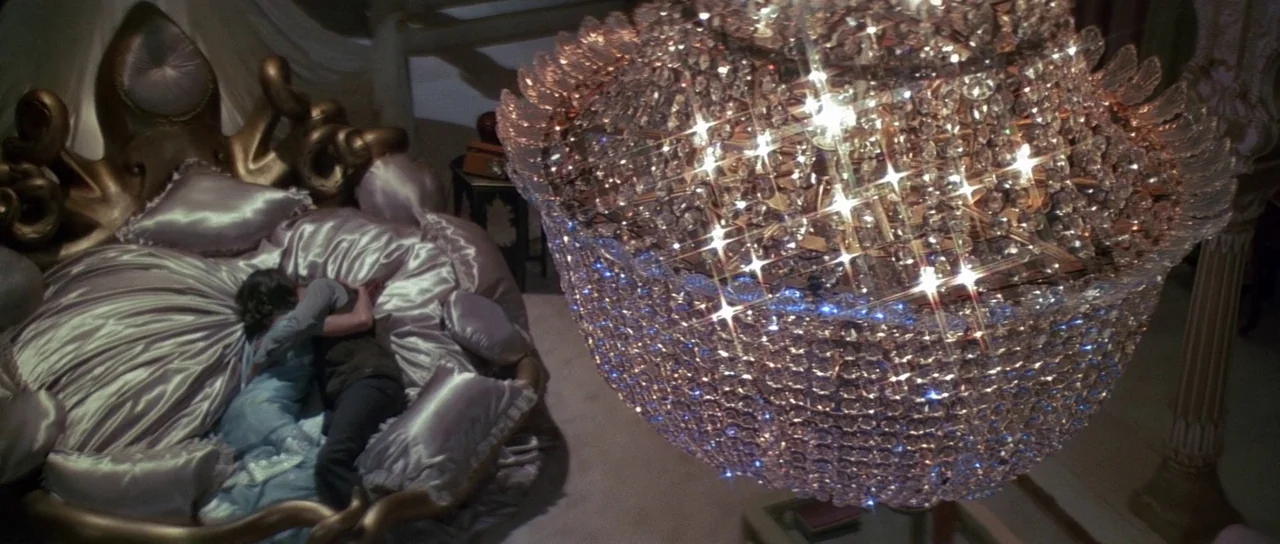 Octopussy (1983) movie still: wide — A lavish circular bed with shiny lavender satin sheets dominates the lower left frame. A large multifaceted…