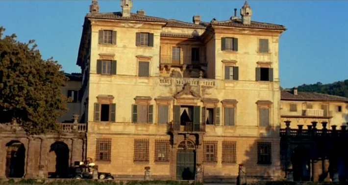 Blood For Dracula (1974) movie still: establishing — A three-story Italian villa with a weathered stucco facade and dark green shutters. The…