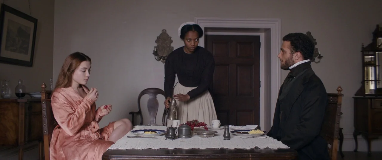 Lady Macbeth (2016) movie still: wide — A sparsely furnished nineteenth-century room features a dark wood table set for breakfast. Three people…