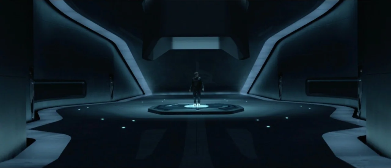 TRON: Legacy (2010) movie still: wide — A spacious, minimalist chamber features smooth dark surfaces and geometric blue lighting conduits. A lone…