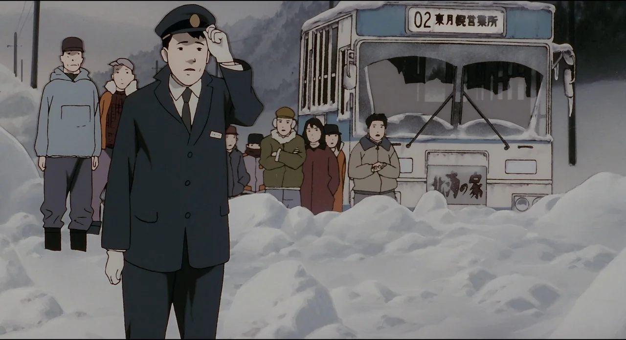 Millenium Actress (2001) movie still: fullbody — A group of people waits in deep snow beside a stationary bus in winter. The bus driver stands in…