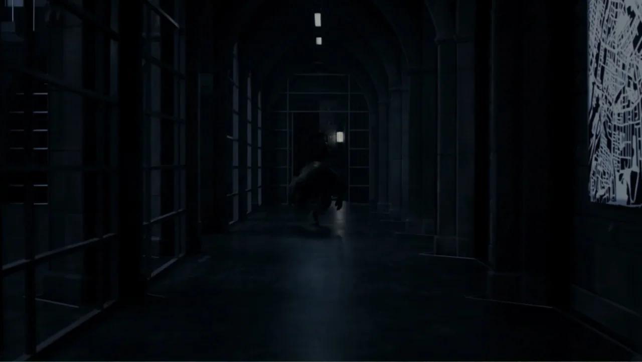 Underworld: Blood Wars (2016) movie still: wide — A long, dark arched corridor with grid-patterned windows on the side walls. A hunched, dark…