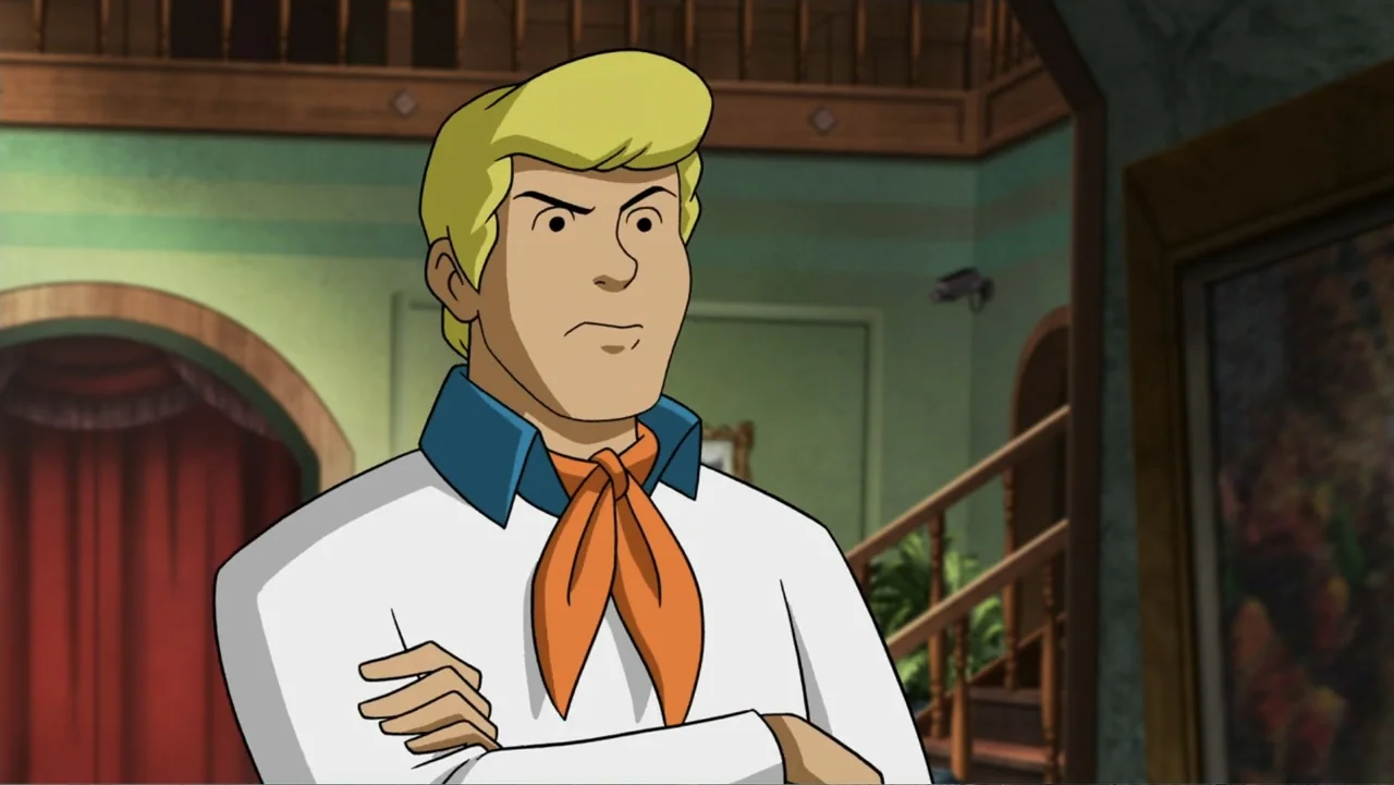 Scooby-Doo! Return to Zombie Island (2019) movie still: medium — A spacious mansion foyer features green walls and a wooden staircase. A young man…