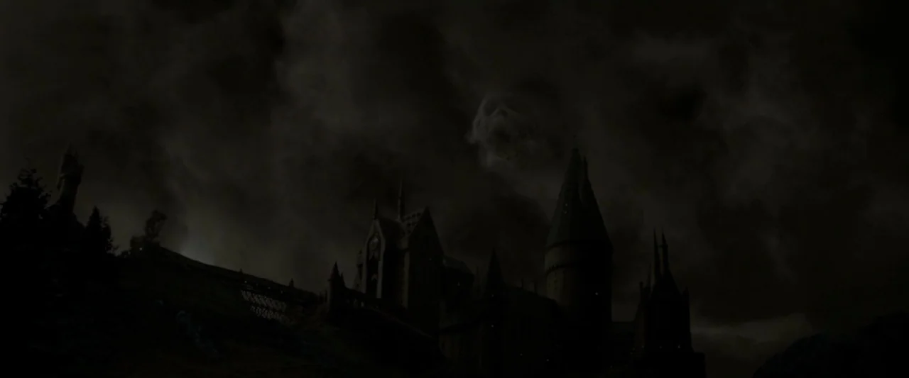 Harry Potter & The Half Blood Prince (2009) movie still: establishing — A dark stone castle silhouette stands against a cloudy, stormy night sky. A…