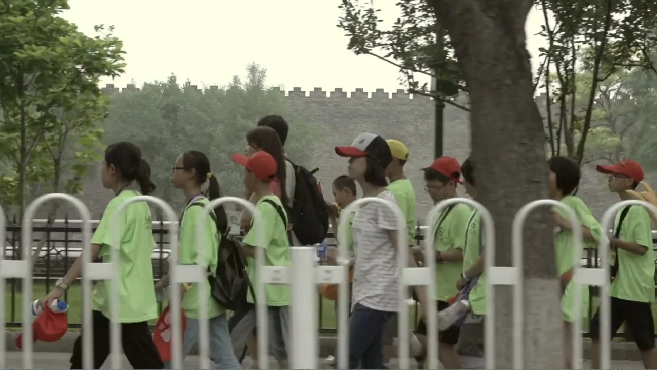 Flowers of Taipei: Taiwan New Cinema (2014) movie still: medium — A group of youth in matching light green shirts walk past a stone wall. The group…