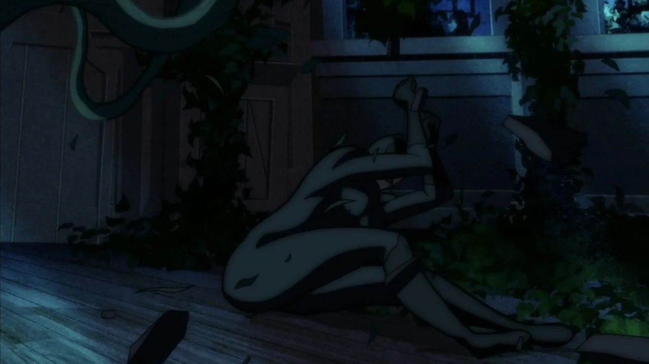 Batman: The Long Halloween, Part Two (2021) movie still: fullbody — An exterior garden at night features overgrown vines and dark, solid…