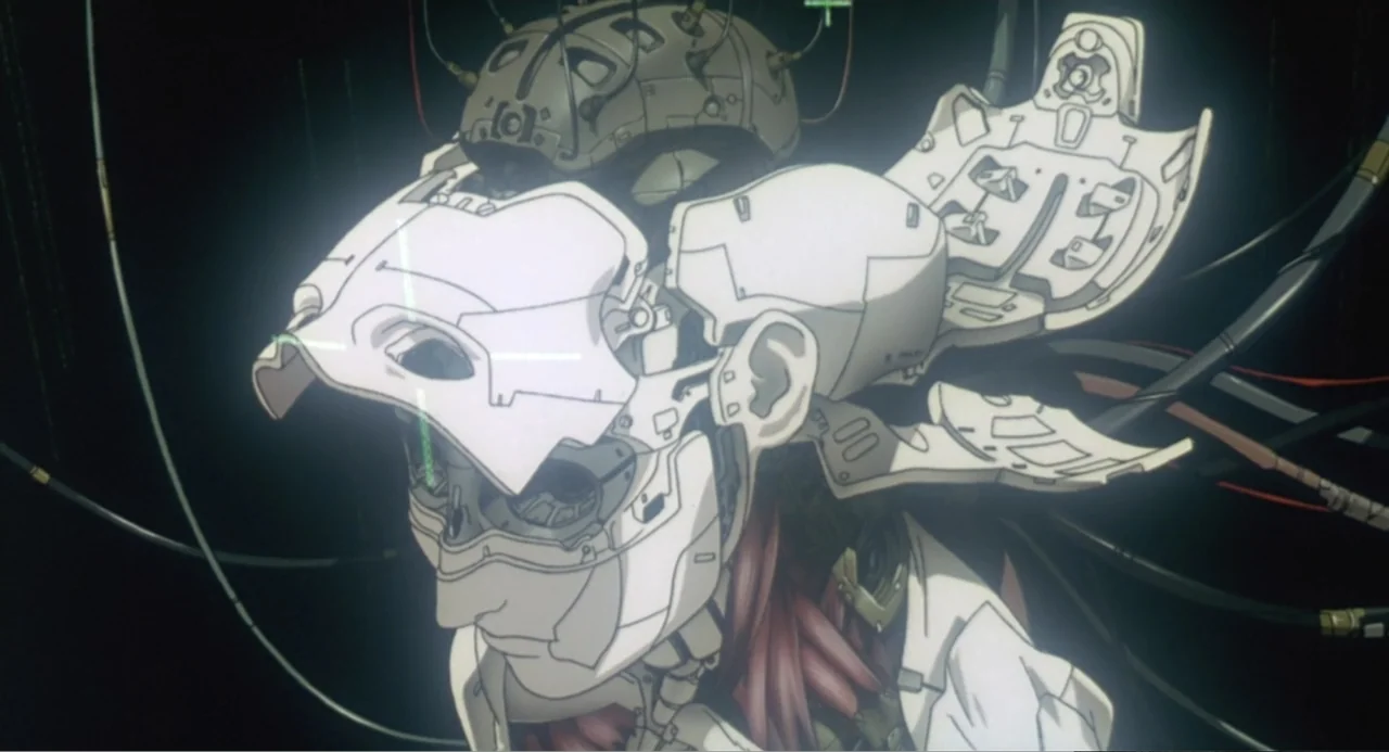 Ghost in the Shell (1995) movie still: closeup — A dark, clinical setting contains a humanoid robot with its exterior head plates opened. Numerous…