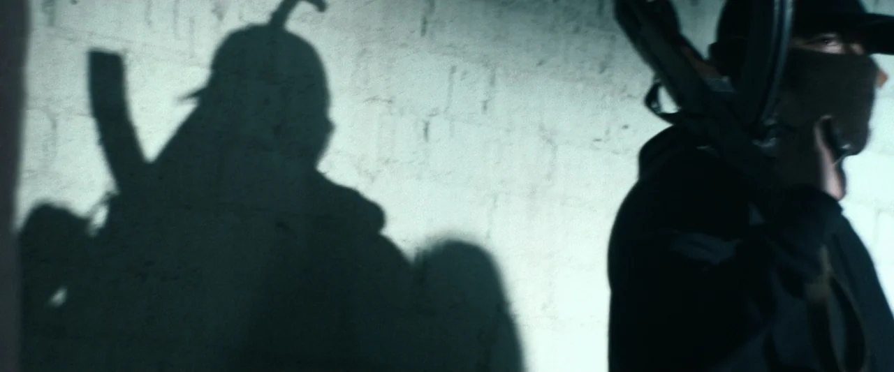 True Account: Breaking the Truce (Yakuza Bloody Chronicles 2) (2007) movie still: medium — A dark interior space features a textured grey concrete…