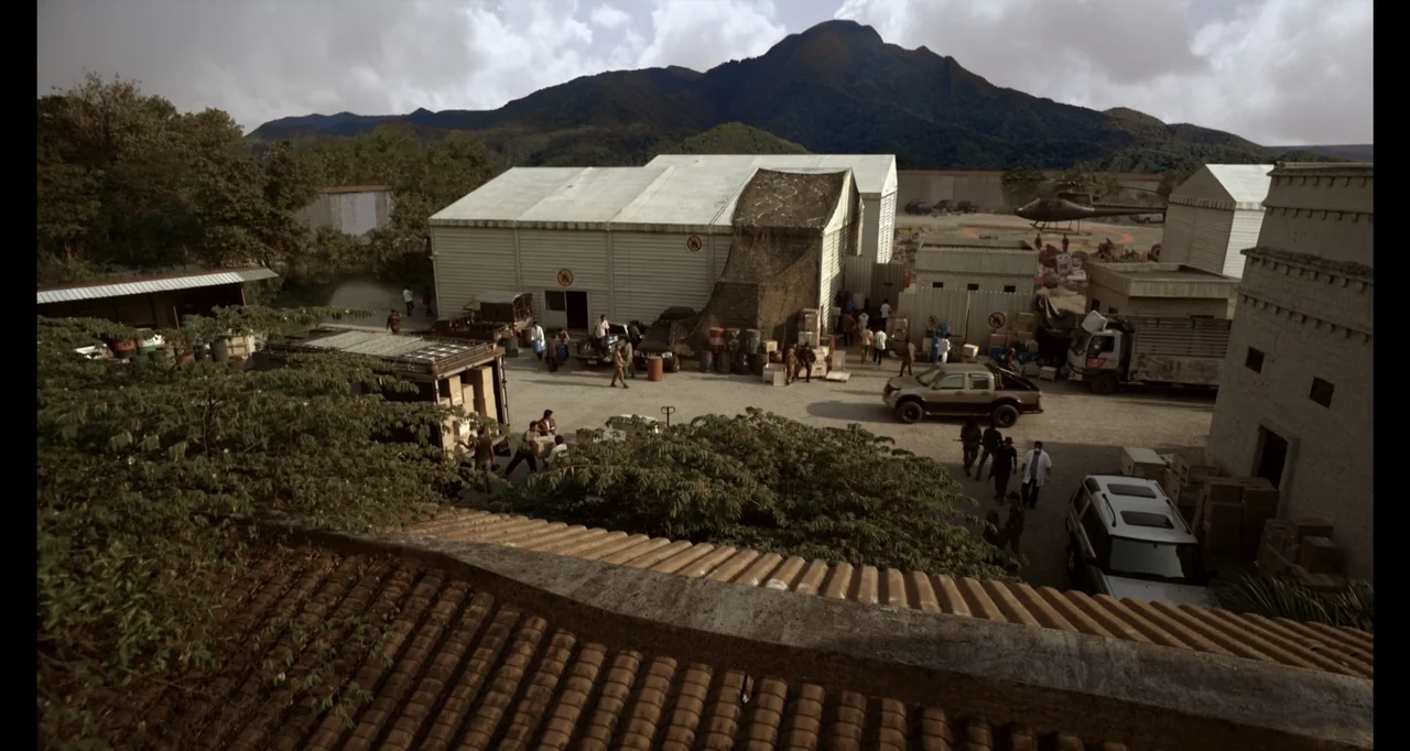 Ninja: Shadow of a Tear (2013) movie still: wide — A military logistics compound sits beneath a range of green, mountainous terrain. Numerous staff…