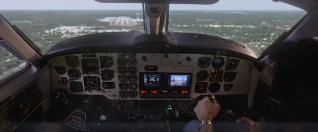 On a Wing and a Prayer (2023) movie still: medium — A light aircraft cockpit features an array of analog gauges and digital navigation screens. A…