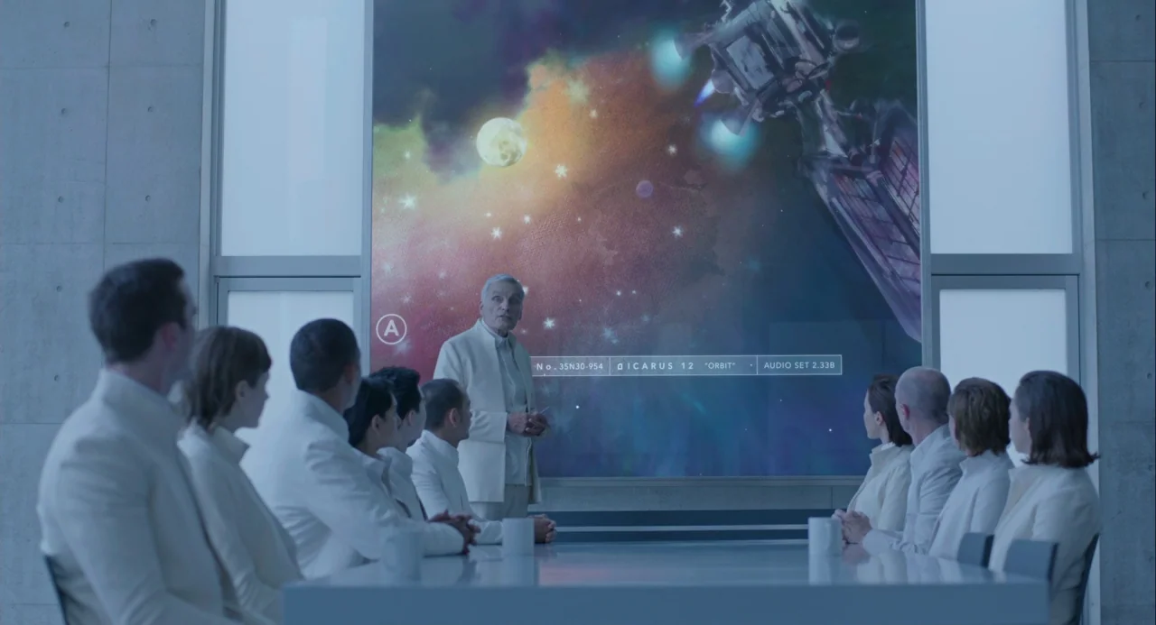 Equals (2015) movie still: wide — A stark, modern conference room features concrete walls and a large, glowing digital screen. A group of…