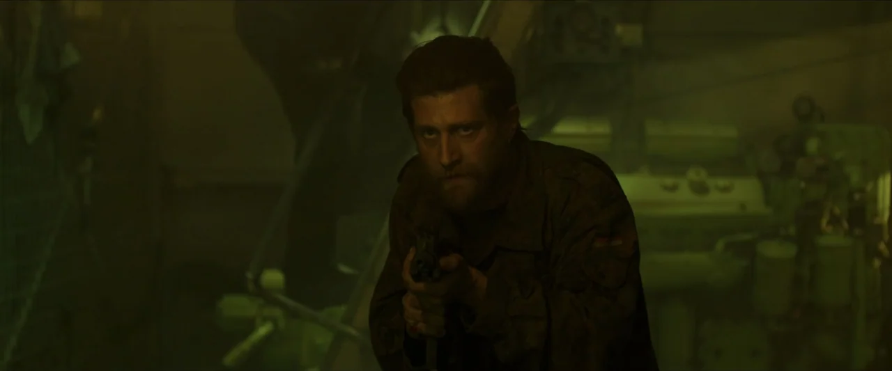 Apocalypse Z: The Beginning of the End (2024) movie still: medium — A dim industrial space is filled with heavy machinery and a pervasive green fog.…