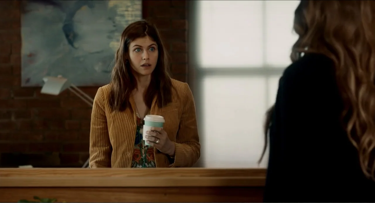 Can You Keep a Secret? (2019) movie still: medium — An interior office space features a dark brick wall and a wooden service counter. A woman in a…