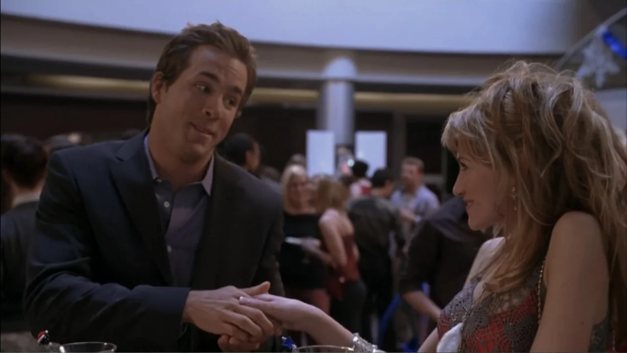 Just Friends (2005) movie still: medium — A crowded social gathering with many people in the background during a night event. A man and a woman…