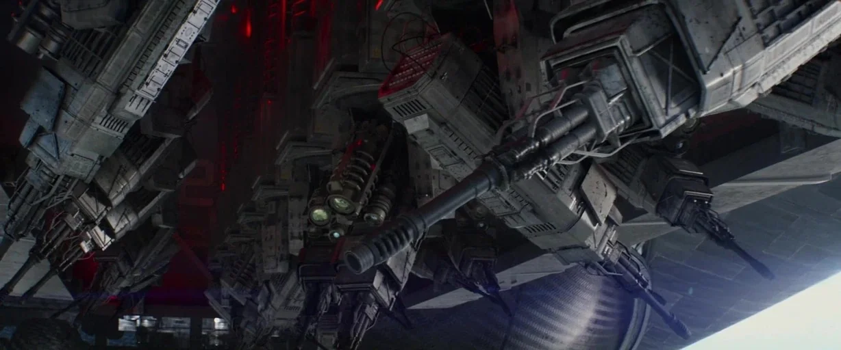 Captain America: The Winter Soldier (2014) movie still: establishing — An underside view of a massive, heavily armed metallic spacecraft hovering in…