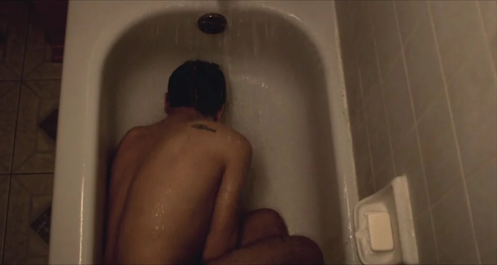 I Killed My Mother (J’ai tué ma mère) (2009) movie still: medium — A white porcelain bathtub with tiled walls contains a person sitting under…