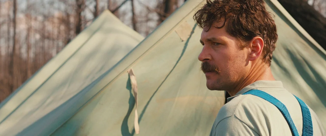 Prince Avalanche (2013) movie still: medium — A campsite in a wooded area features two light-green canvas tents standing together. A man in his…