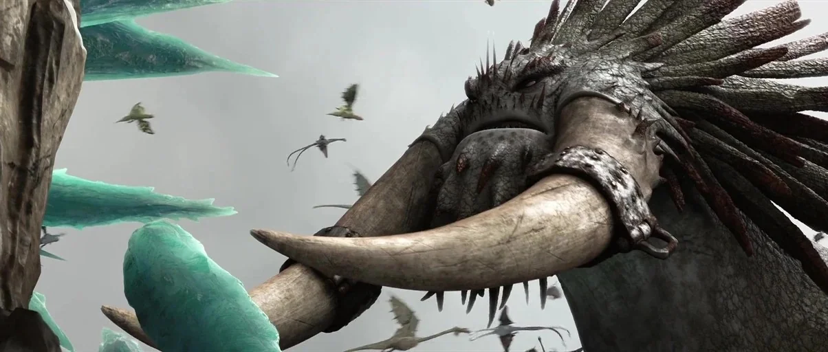 How to Train Your Dragon 2 (2014) movie still: medium — A gargantuan creature with long tusks stands against a rocky cliff with icy formations.…