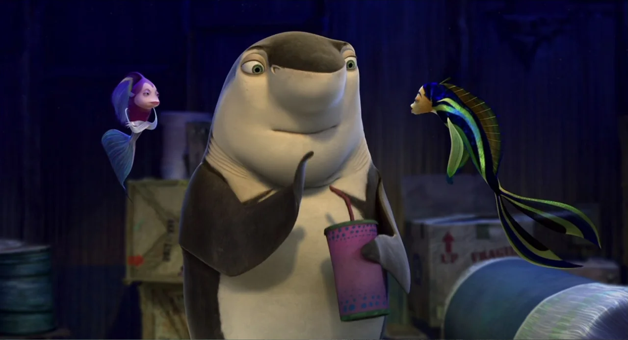 Shark Tale (2004) movie still: medium — Three animated fish characters gather in a dimly lit, shadowy room filled with boxes. A central shark…
