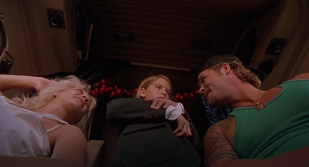 The Heart Is Deceitful Above All Things (2004) movie still: medium — The interior of a vehicle cabin features three people sitting together in the…