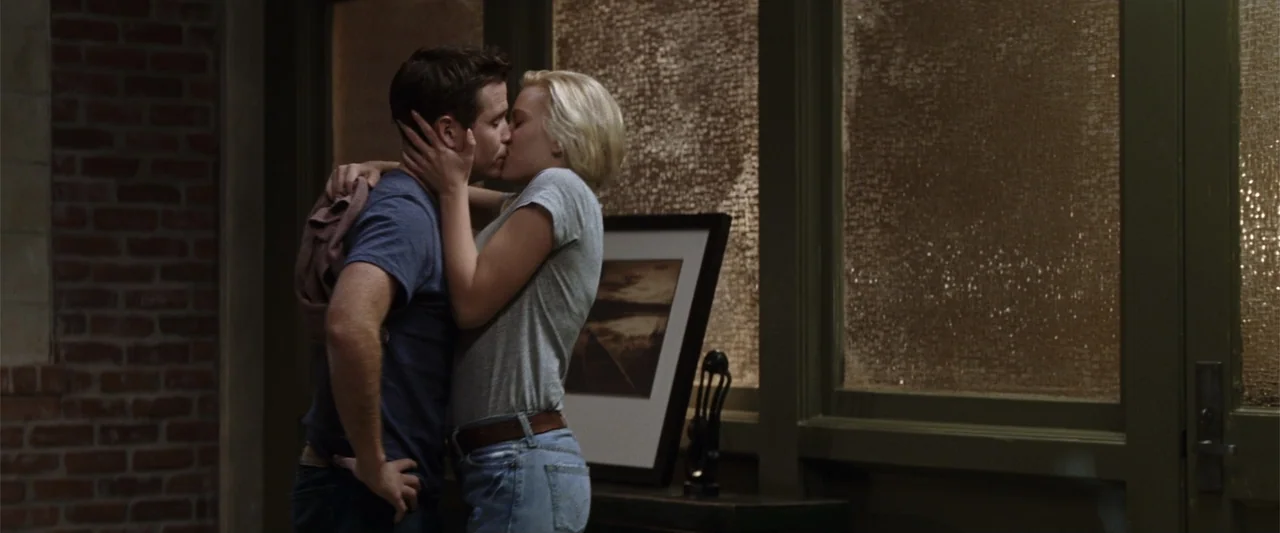 He's Just Not That Into You (2009) movie still: medium — An interior space features exposed brick walls and frosted glass windows at night. A young…