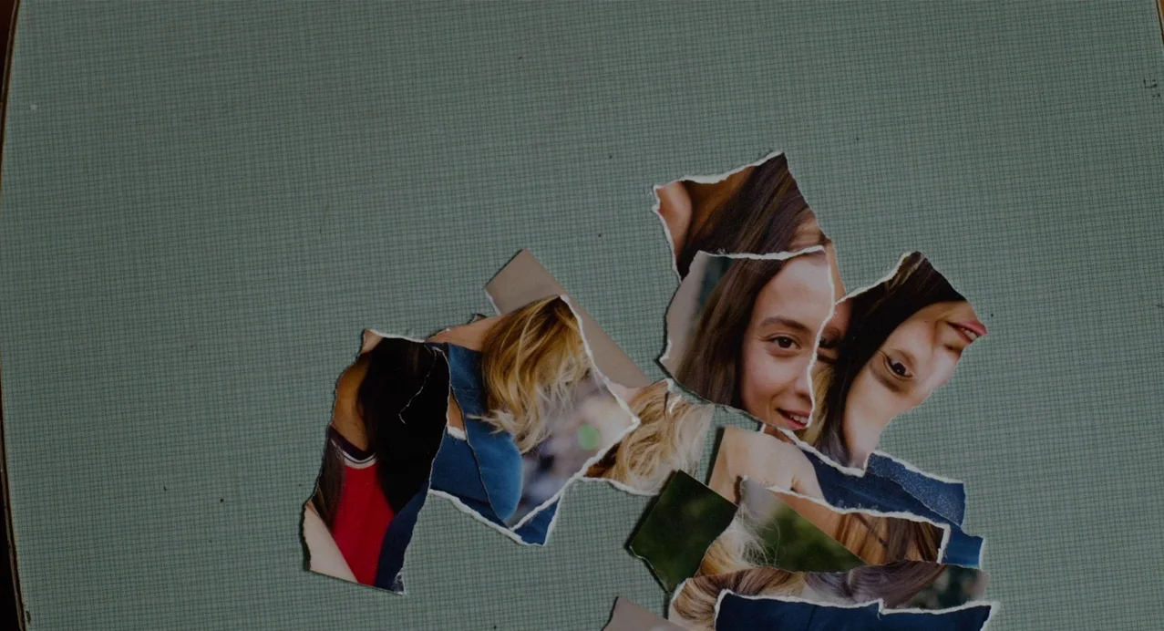 Julieta (2016) movie still: closeup — A light green, grid-textured surface holds several jagged torn pieces of a photograph. The pieces show…