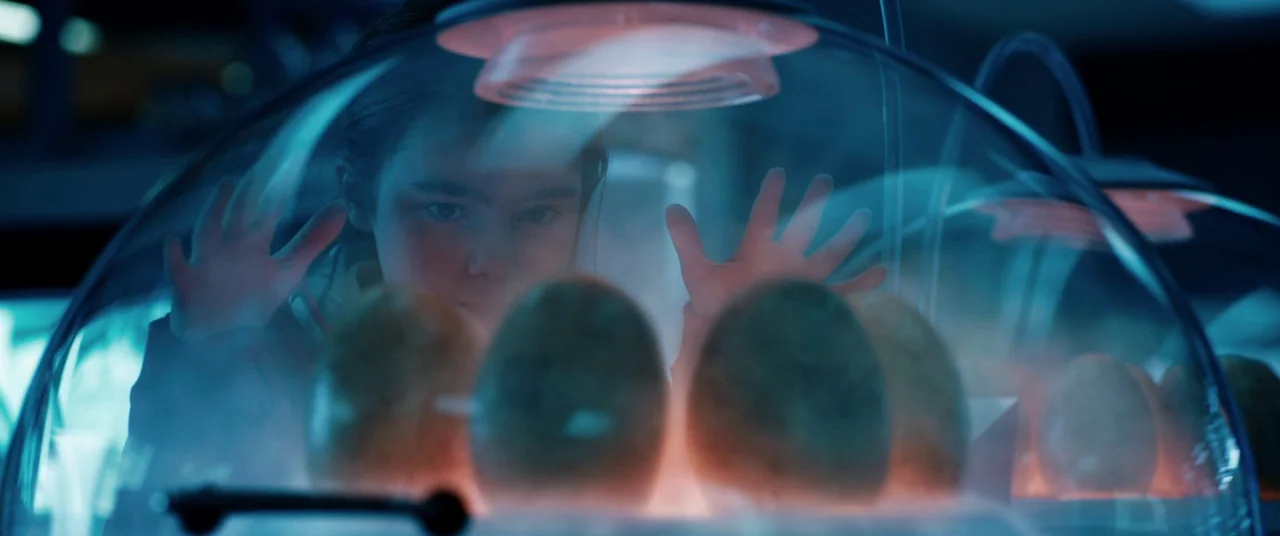 Jurassic World: Fallen Kingdom (2018) movie still: medium — A dark laboratory interior features a glass incubator housing several large, mottled…