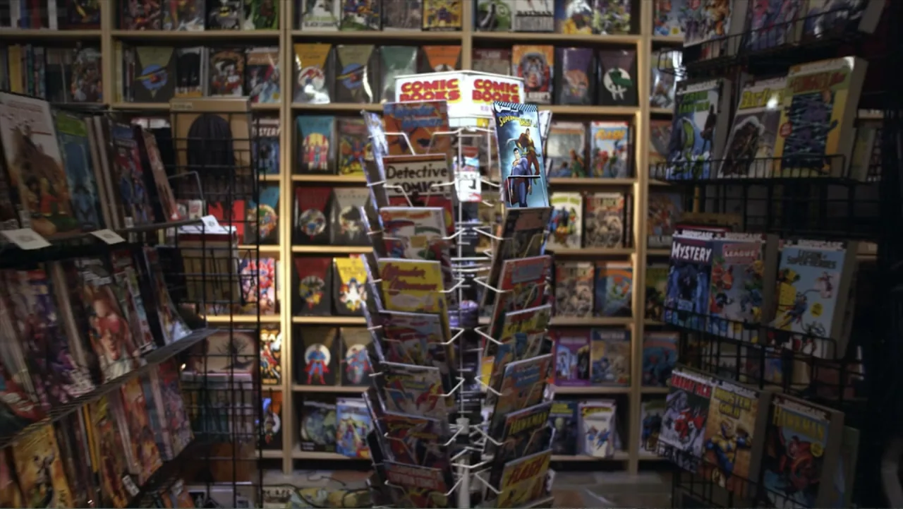 Superman/Shazam!: The Return of Black Adam (2010) movie still: medium — A dense collection of comic book racks fills a retail store interior space.…
