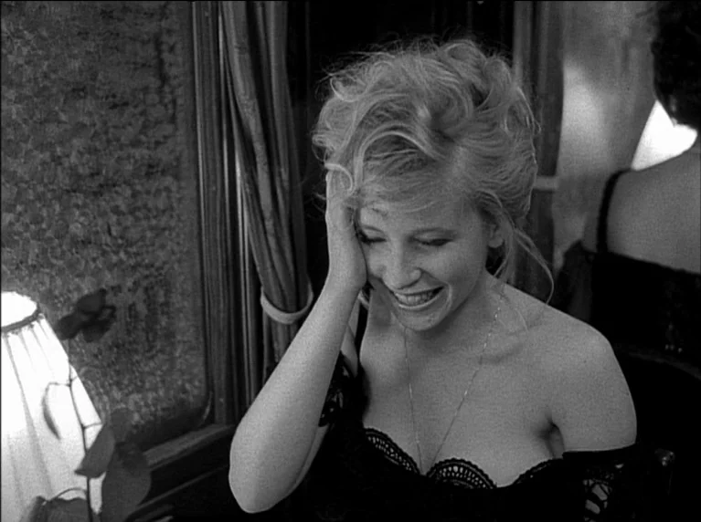 My 20th Century (1989) movie still: medium — A woman sits inside a train car next to a window with drawn curtains. She rests her face against her…