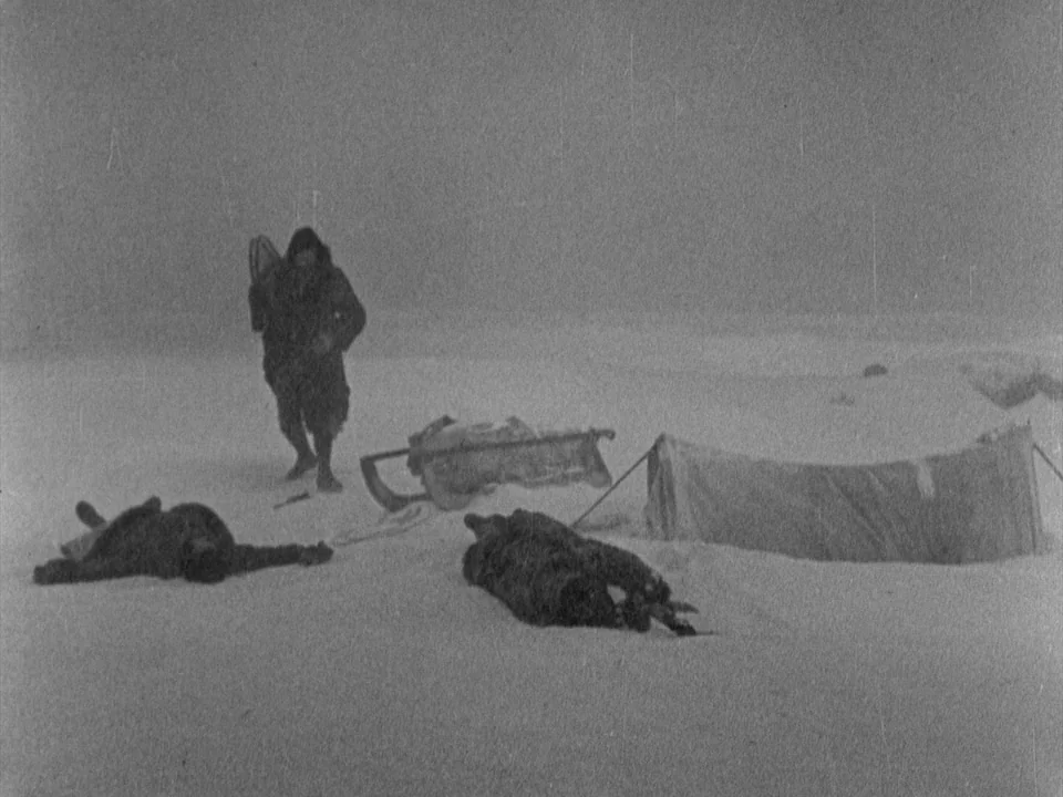 The Gold Rush (1925) movie still: wide — A desolate, snowy arctic expanse with a low-lying, wind-swept, featureless horizon. A lone person in heavy…