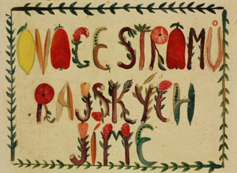 Fruit of Paradise (1970) movie still: closeup — A parchment-like surface features hand-painted letters composed of various fruits and vegetables.…
