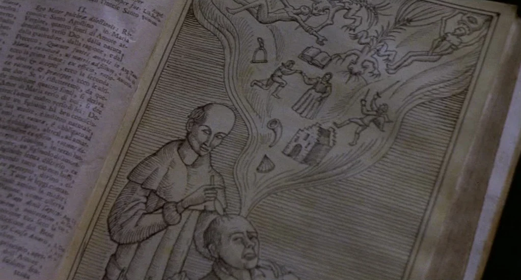 Demons of the Mind (1972) movie still: closeup — A close-up view shows a medieval woodcut illustration on an aged paper page. The print depicts a…